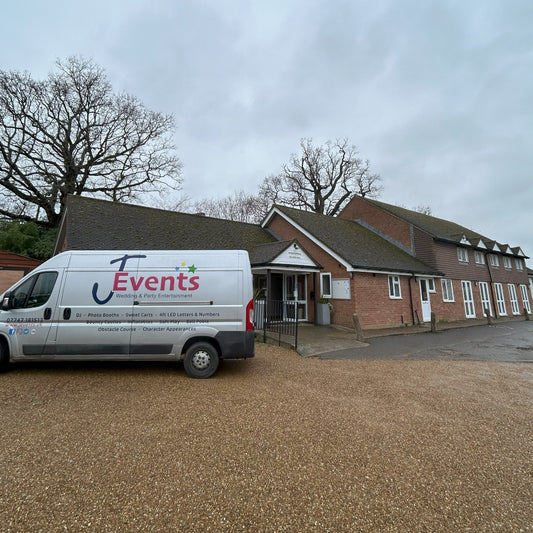 Van with 'J Events' logo parked in front of Robertsbridge Village Hall